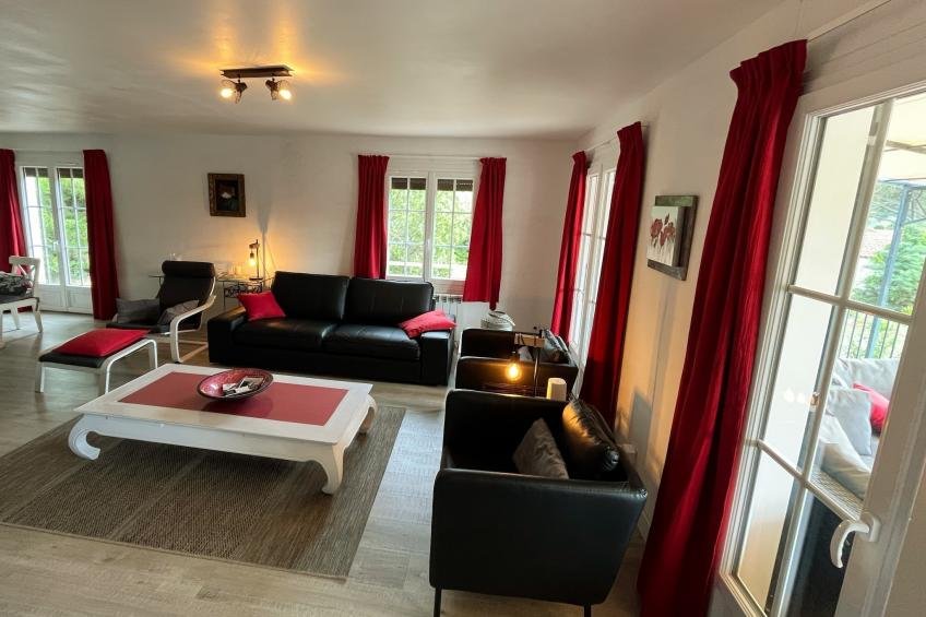 Bright living room at Arcolan with French doors opening to the garden